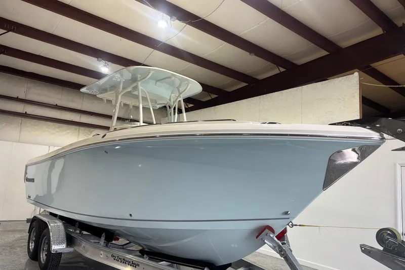 Slide: The Image of 2024 Sailfish 242 CC boat on trailer in indoor showroom. - 5