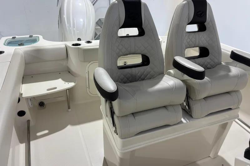 Slide: The Image of 2024 Sailfish 242 CC boat interior with dual engines and fishing rod holders. - 8