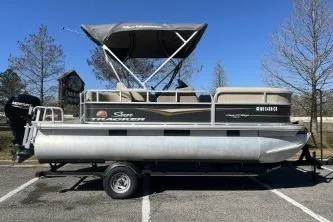 The Image of 2021 Sun Tracker Party Barge 18 DLX pontoon boat on trailer, parked outdoors. - 1