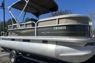 Slide: The Image of 2021 Sun Tracker Party Barge 18 DLX pontoon boat on trailer, side view. - 5
