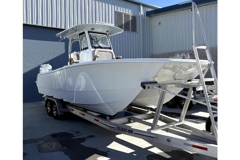 Slide: The Image of 2026 Freeman 28 boat on trailer outside warehouse. - 4
