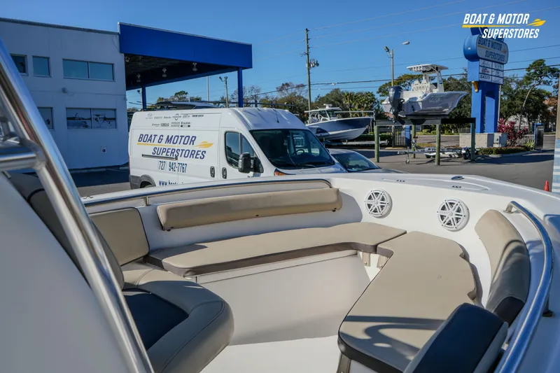Slide: The Image of 2019 Tidewater 198 CC Adventure boat interior at dealership with service van in background. - 11