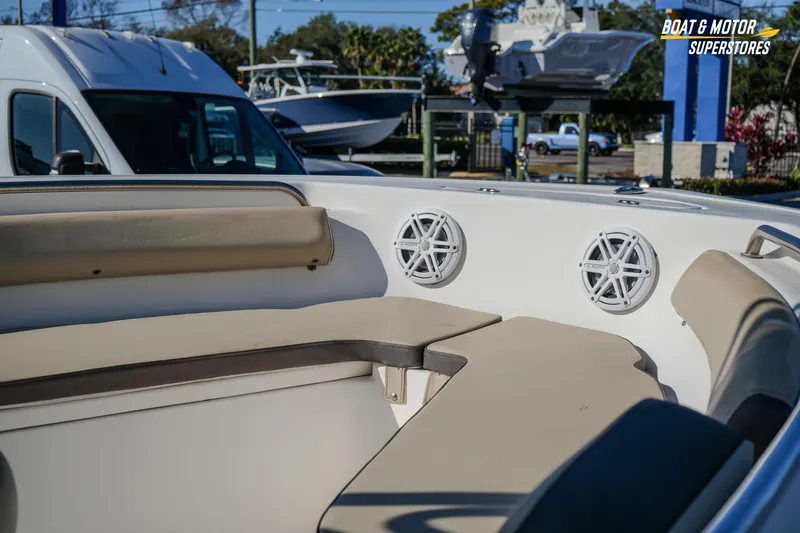 Slide: The Image of 2019 Tidewater 198 CC Adventure boat interior with cushioned seating and speakers. - 12