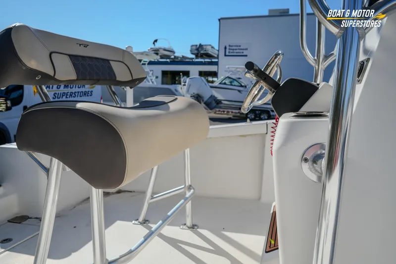 Slide: The Image of 2019 Tidewater 198 CC Adventure boat interior with steering wheel and seating. - 13
