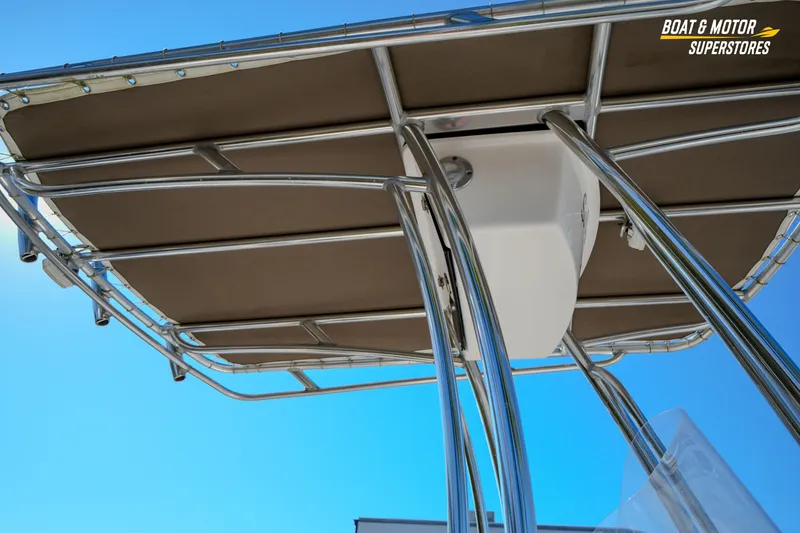 Slide: The Image of 2019 Tidewater 198 CC Adventure boat T-top frame against clear blue sky. - 14