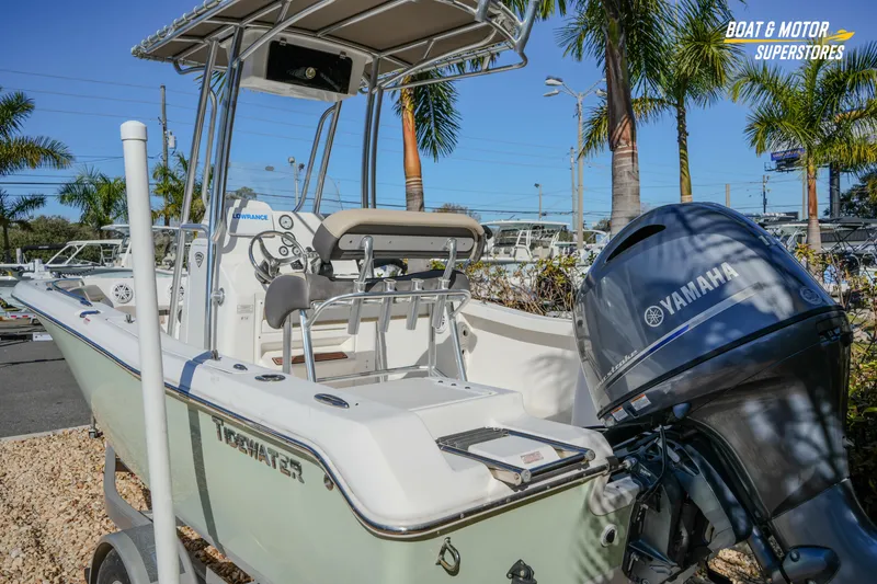 Slide: The Image of 2019 Tidewater 198 CC Adventure boat with Yamaha engine, displayed outdoors. - 22