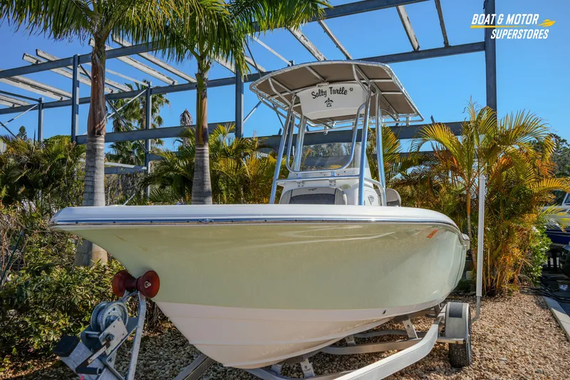 Slide: The Image of 2019 Tidewater 198 CC Adventure boat on trailer, surrounded by palm trees. - 3