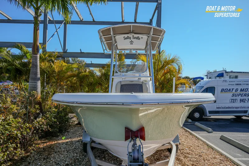 Slide: The Image of 2019 Tidewater 198 CC Adventure boat displayed at dealership with tropical backdrop. - 6