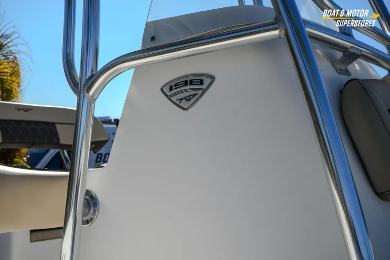 Slide: The Image of 2019 Tidewater 198 CC Adventure boat detail with logo and railing. - 9