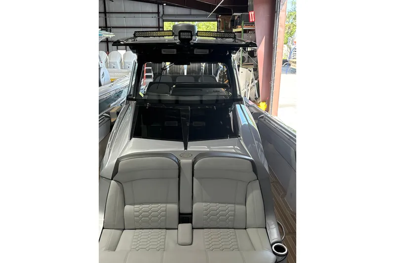 Slide: The Image of 2024 Nor-Tech boat interior with sleek seating and modern design in a showroom. - 10