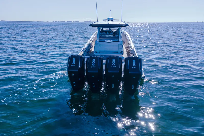 Slide: The Image of 2024 Nor-Tech 500 Sport Center Console with quad 600 V12 engines on open water. - 12