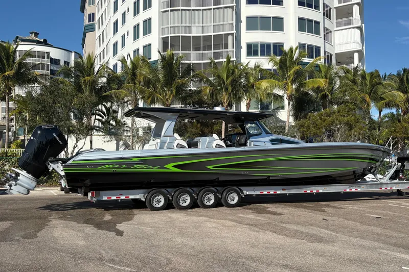Slide: The Image of 2024 Nor-Tech 500 Sport Center Console boat on clear blue water. - 2