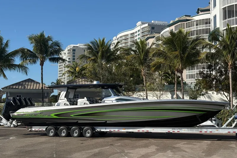 Slide: The Image of 2024 Nor-Tech 500 Sport Center Console boat on clear green water. - 3