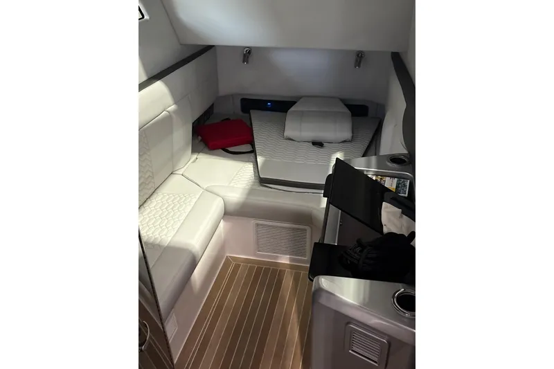 Slide: The Image of 2024 Nor-Tech boat with green accents on a trailer, parked near a modern building. - 5