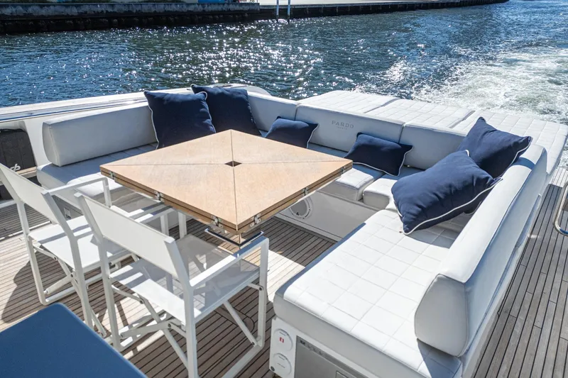 Slide: The Image of Luxurious seating area on 2019 Pardo Yachts P50, featuring elegant cushions and a wooden table. - 15