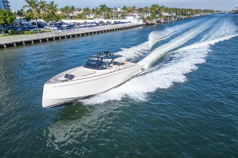Slide: The Image of 2019 Pardo Yachts P50 cruising on a sunny waterway, surrounded by palm trees. - 6