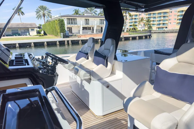 Slide: The Image of Luxurious 2019 Pardo Yachts P50 interior with plush seating and modern helm, dockside view. - 16