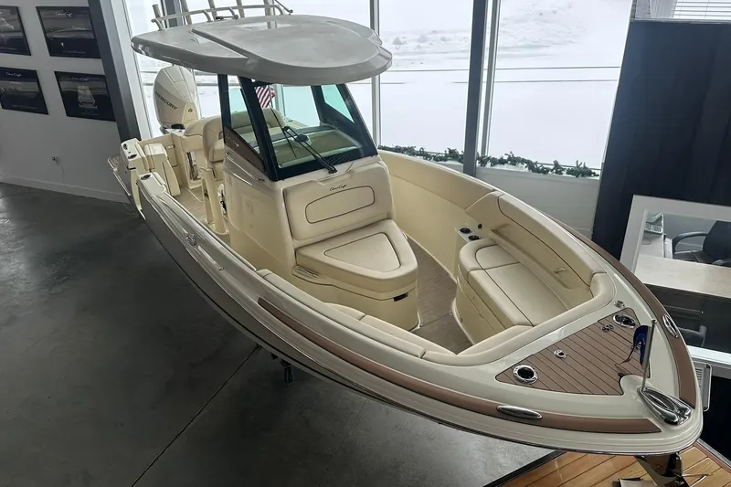 Slide: The Image of 2024 Chris-Craft Catalina 24 boat displayed indoors, showcasing elegant design and spacious seating. - 1