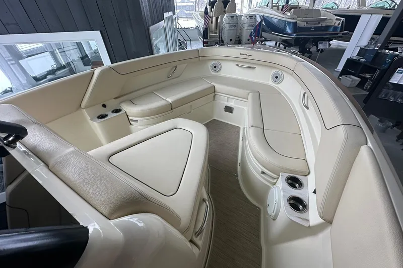 Slide: The Image of 2024 Chris-Craft Catalina 24 boat interior with beige seating and cup holders. - 10