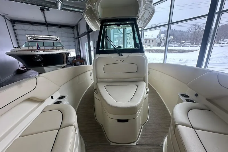 Slide: The Image of 2024 Chris-Craft Catalina 24 interior with luxurious seating in a showroom setting. - 13