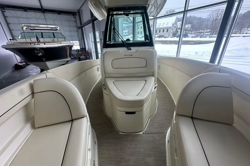Slide: The Image of 2024 Chris-Craft Catalina 24 interior with elegant seating in a showroom setting. - 14