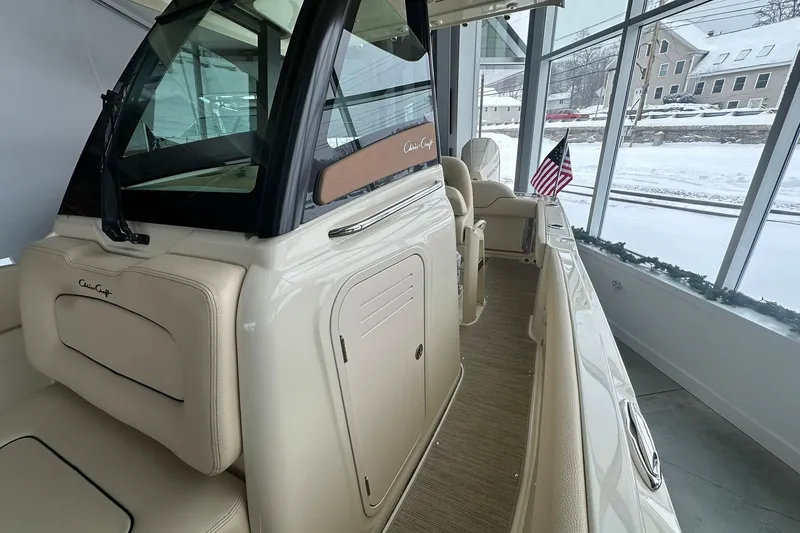 Slide: The Image of 2024 Chris-Craft Catalina 24 boat interior with American flag, displayed in showroom. - 17