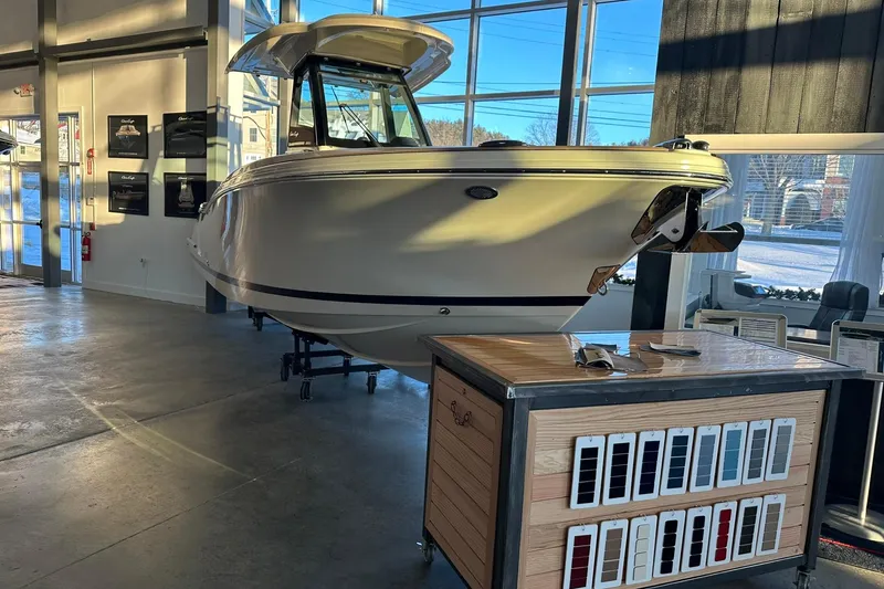 Slide: The Image of 2024 Chris-Craft Catalina 24 boat displayed indoors with color samples. - 2