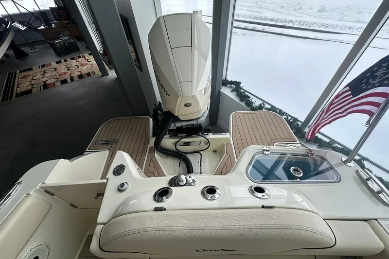 Slide: The Image of 2024 Chris-Craft Catalina 24 boat interior with American flag and outboard motor. - 23