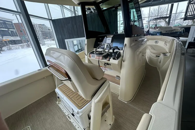 Slide: The Image of 2024 Chris-Craft Catalina 24 boat interior with helm and seating in showroom. - 6