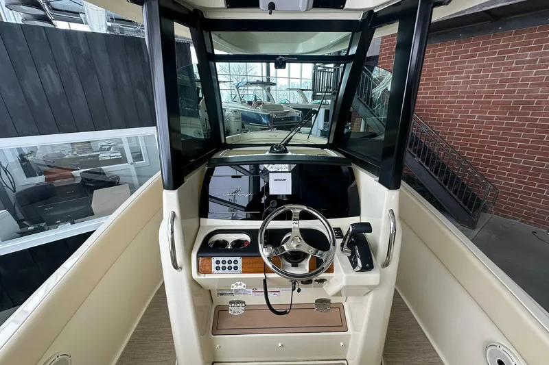 Slide: The Image of 2024 Chris-Craft Catalina 24 boat helm with steering wheel and controls. - 7