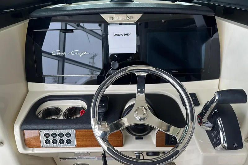 Slide: The Image of 2024 Chris-Craft Catalina 24 helm with steering wheel and control panel. - 8