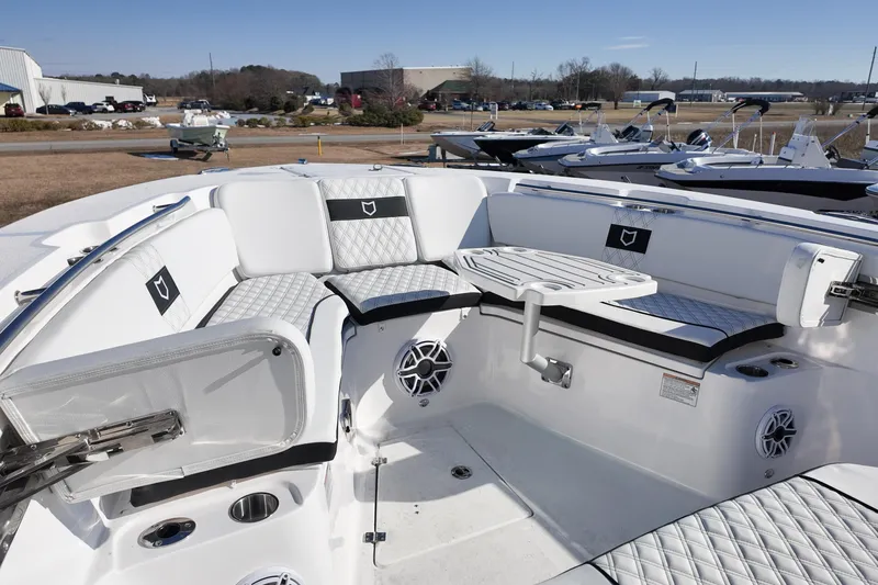 Slide: The Image of 2026 Sea Fox 328 Commander boat interior with white seating and table. - 10