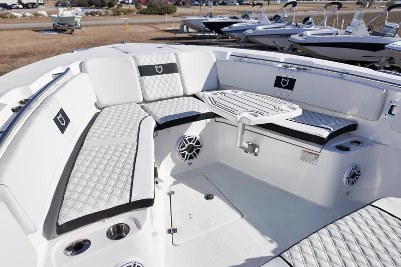 Slide: The Image of 2026 Sea Fox 328 Commander boat interior with cushioned seating and table. - 12