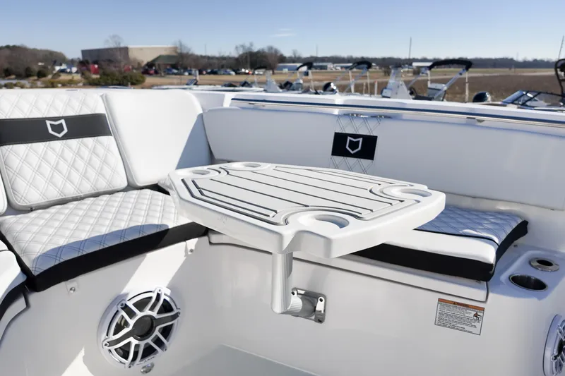 Slide: The Image of Luxurious seating area on 2026 Sea Fox 328 Commander boat with table and speaker. - 13