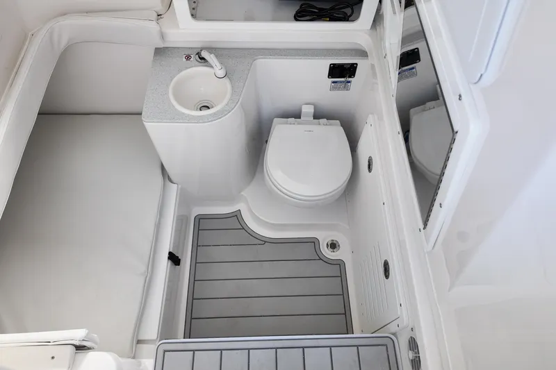 Slide: The Image of 2026 Sea Fox 328 Commander boat bathroom with sink, toilet, and mirror. - 14