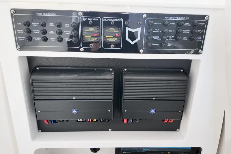 Slide: The Image of Control panel of 2026 Sea Fox 328 Commander boat with amplifiers and circuit switches. - 17