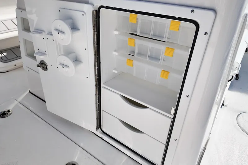 Slide: The Image of Open storage compartment on 2026 Sea Fox 328 Commander boat, featuring organized shelves and drawers. - 40