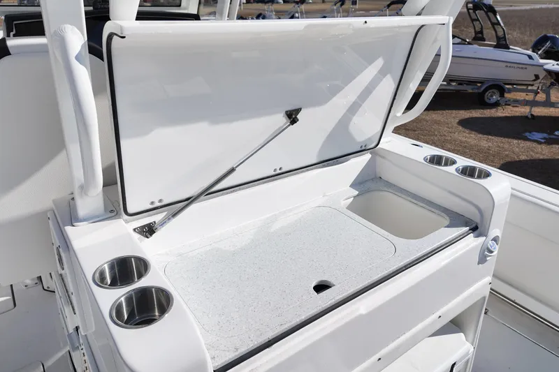 Slide: The Image of 2026 Sea Fox 328 Commander boat with open storage compartment and cup holders. - 43