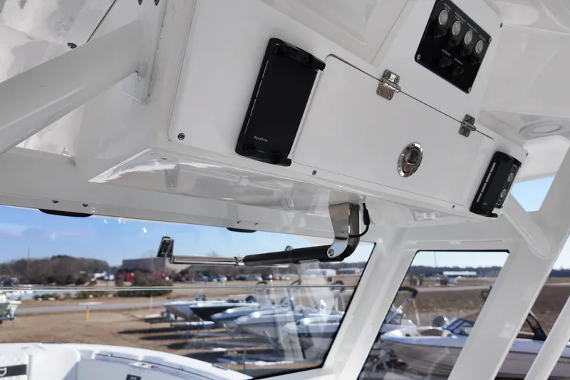 Slide: The Image of Interior view of 2026 Sea Fox 328 Commander boat, showcasing control panel and storage. - 49
