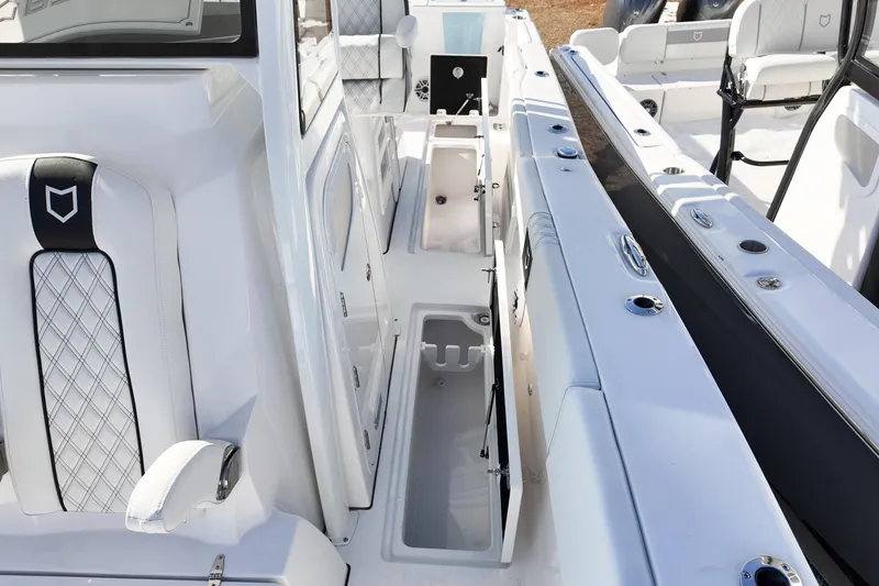 Slide: The Image of 2026 Sea Fox 328 Commander interior with white seating and storage compartments. - 6