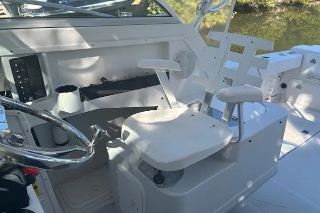 Slide: The Image of 2008 Glacier Bay 2670 Cuddy boat interior with steering wheel and seating. - 10