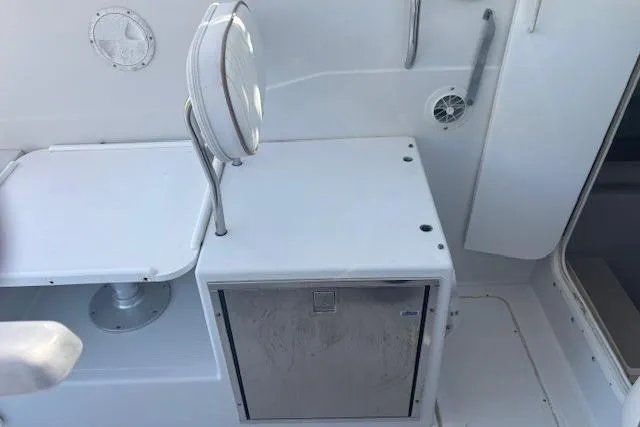 Slide: The Image of 2008 Glacier Bay 2670 Cuddy boat interior with seating and storage area. - 11