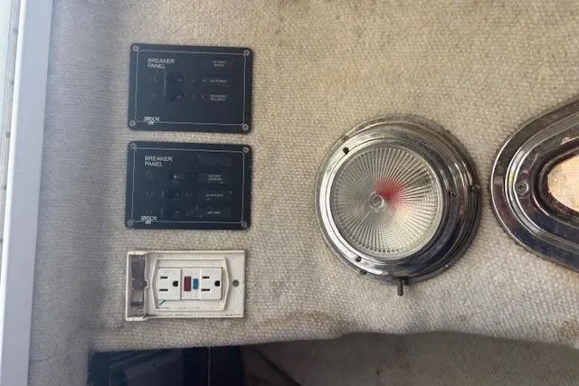 Slide: The Image of 2008 Glacier Bay 2670 Cuddy interior with breaker panels and light fixture. - 13