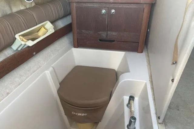 Slide: The Image of 2008 Glacier Bay 2670 Cuddy interior with storage and seating area. - 14