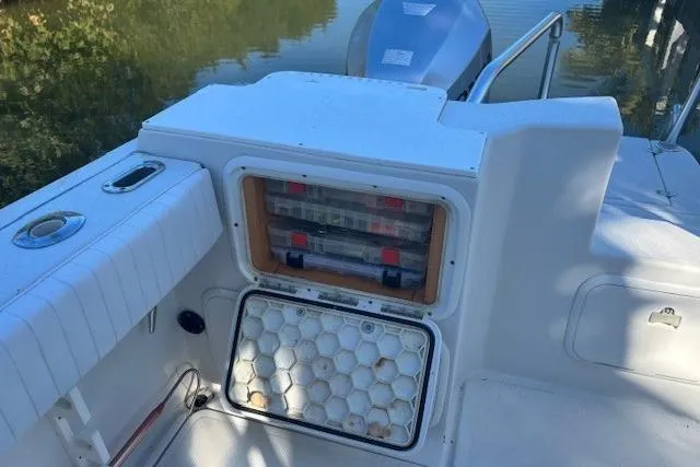 Slide: The Image of 2008 Glacier Bay 2670 Cuddy boat interior with storage compartments and seating. - 19