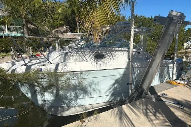 Slide: The Image of 2008 Glacier Bay 2670 Cuddy boat docked under palm trees. - 2