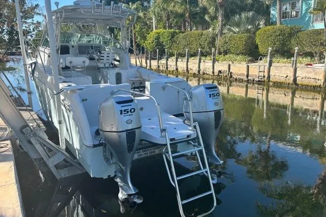Slide: The Image of 2008 Glacier Bay 2670 Cuddy boat docked, featuring dual 150 horsepower engines. - 25