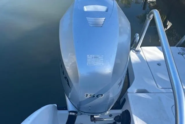 Slide: The Image of Outboard motor on 2008 Glacier Bay 2670 Cuddy boat, docked on calm water. - 26