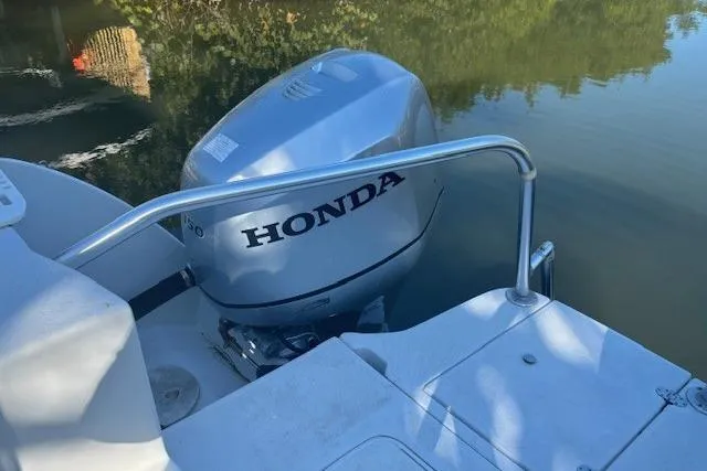 Slide: The Image of 2008 Glacier Bay 2670 Cuddy with Honda outboard motor on calm water. - 28