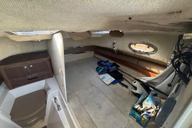 Slide: The Image of Interior of 2008 Glacier Bay 2670 Cuddy boat, featuring seating and storage areas. - 30